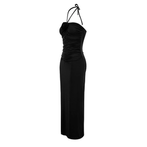Detail of black halter maxi dress featuring a 3D floral accent and ruched fabric texture