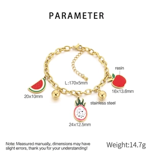 Macro detail of stainless steel fruit bracelet with dragon fruit and watermelon charms