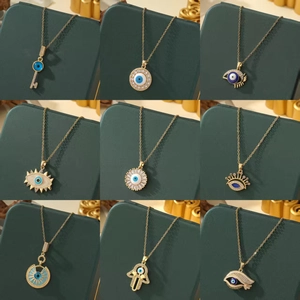 Collection of golden Turkish Evil Eye and Hamsa Hand pendant necklaces for women