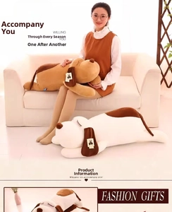 Close-up of soft plush puppy pillows in brown and white spots on a white sofa