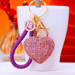 Purple rhinestone heart keychain with woven leather strap and golden lucky charm