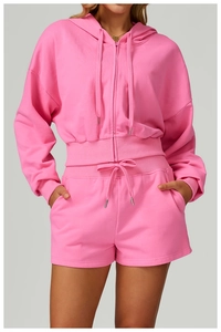 Detail of pink zip-up hoodie set with ribbed cuffs and adjustable drawstring waistband