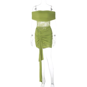 Detail of green lace patchwork dress with off-shoulder neckline and ruched details