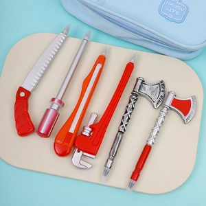 Macro shot of creative tool-shaped ballpoint pens including saw, screwdriver and axe styles