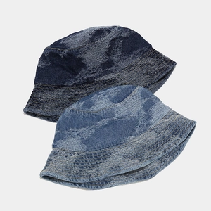 Detail view of denim bucket hats in dark and light blue wash with vintage textures