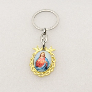 Close-up of Sacred Heart of Jesus religious pendant keychain with golden frame