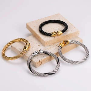 Unisex C-shaped twisted cable steel bracelets in gold, black, and silver finishes