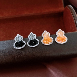 Macro detail of hulu stud earrings with champagne and black crystals set in silver