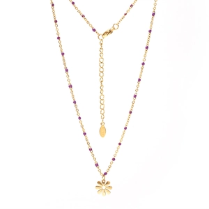 Detail of gold stainless steel necklace featuring purple beads and a small flower pendant