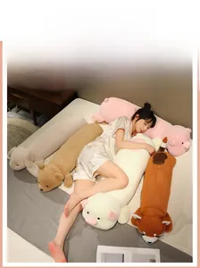 Long animal plush pillows including pink pig and brown bear in a cozy bedroom setting