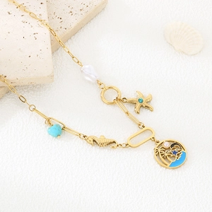 Detail of gold ocean necklace with starfish, seahorse, pearl and blue heart pendant