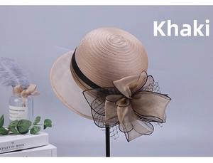 Detail of khaki organza floral sun hat with large bow and mesh veil on a hat stand