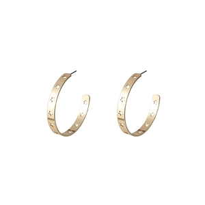 Detailed view of gold C-shaped earrings with hollow star cutouts on a white background