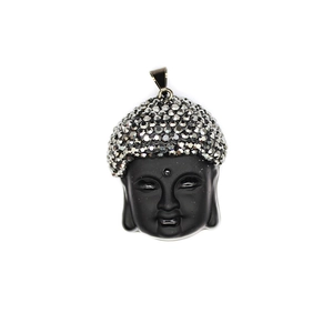 Macro view of black glass Buddha pendant with sparkling silver rhinestones and gold trim