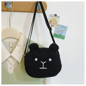 Close-up of cute black plush bear crossbody bag with adjustable strap for kids