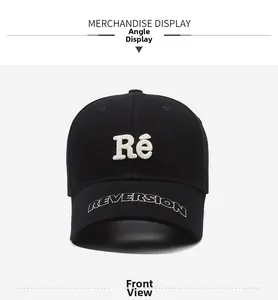 Detail of black cotton baseball cap featuring white 3D Ré embroidery and Reversion brim