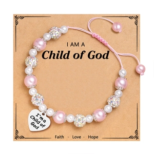 Pink and white pearl bracelet with heart pendant on a God themed display card