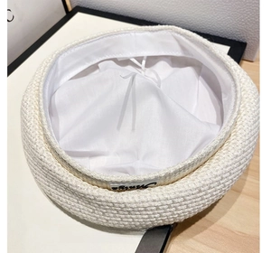 Detailed close-up of white woven beret featuring inner lining and adjustable drawstring