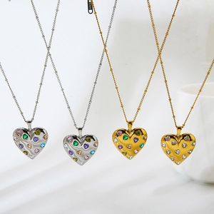 Detail of colorful heart zircons and S.steel hallmark on gold and silver necklaces