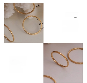 Detail of minimalist 18k gold plated surgical titanium steel rings with a smooth finish