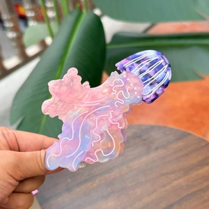 Detailed view of pink and purple gradient acetate jellyfish hair claw clip with wave edges