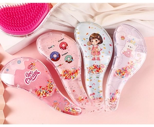 Detail view of transparent detangling hair combs with colorful beads and cartoon patterns