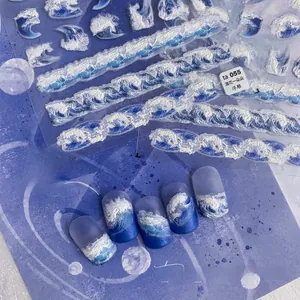 Close-up of blue and white wave relief nail art stickers with 3D texture and sea patterns