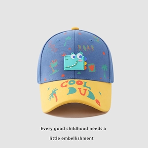 Detail of kids baseball cap with ROAR embroidery and cute green dinosaur patch
