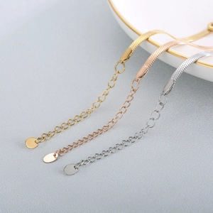 Detailed macro view of gold, rose gold and silver flat blade chains with adjustable clasps