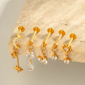 Five pieces of F136 titanium gold piercings with moon star and flower zircon charms