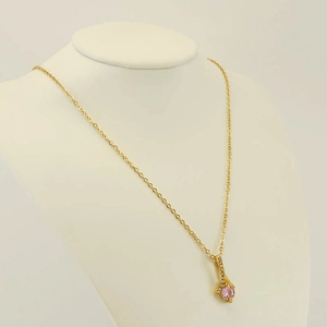 Elegant gold-plated necklace with pink teardrop gemstone pendant on neck mannequin