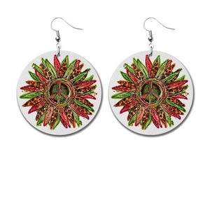 Detailed view of bohemian peace sign and sunflower teardrop earrings with leopard patterns