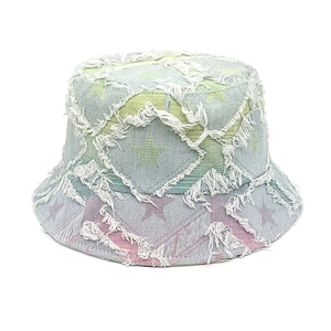 Close-up of fringe edges and star patchwork on gradient denim bucket hat
