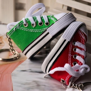 Miniature canvas shoe keychains in red and green with realistic laces and metal rings