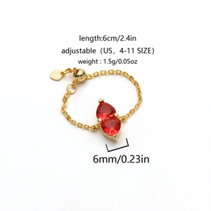 Detail view of adjustable gold-tone chain ring with faceted red heart-shaped gemstones