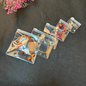 Various sizes of transparent EVA self-sealing bags for jewelry storage on black background