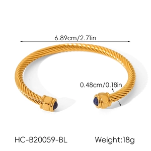 Macro shot of gold cable bangle with blue stones showing dimensions and 18g weight details