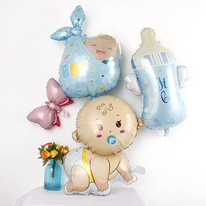 Detail of pink and blue baby shower foil balloons shaped as bottles and bows for party decor