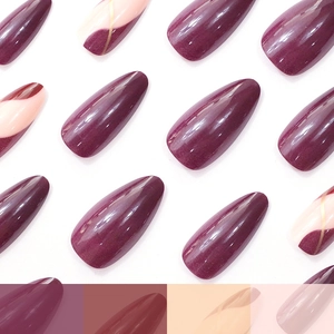 Almond shaped press-on nails in plum purple and nude pink with elegant gold wavy lines