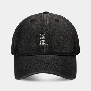 Close-up of cute dog embroidery on black washed denim baseball cap with fine texture