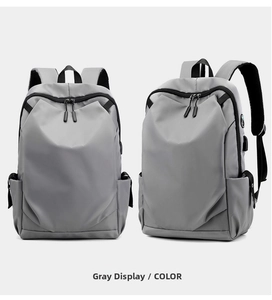 Detailed front and side view of grey oxford backpack featuring external USB charging port