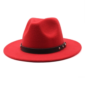 Close-up of red wool felt fedora with black leather band featuring silver metal rivets