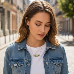 Bohemian gold necklace featuring a colorful enamel cylinder pendant with Evil Eye symbols