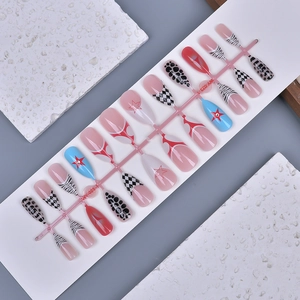 Macro detail of 24pcs almond press-on nails with star patterns and animal prints