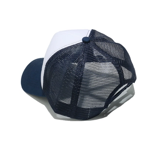 Detail view of breathable navy mesh fabric and stitching on trucker hat back