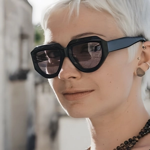 Close-up shot of a model wearing black irregular geometric frame vintage fashion sunglasses