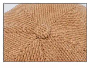 Detailed macro view of the brown corduroy cap top with six-panel stitching and button