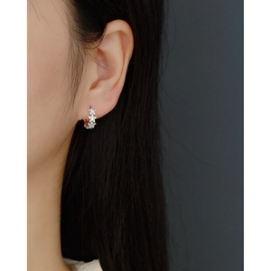 Detailed view of S925 sterling silver hoop earrings with star-shaped zircon pavé stones
