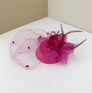 Elegant rose red bridal fascinator with feather accents and mesh veil for cocktail parties