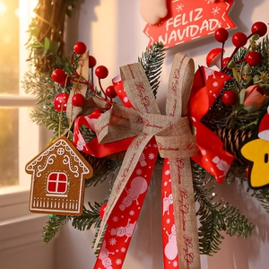 Detail of Christmas wreath with red berries, pine needles and a wooden gingerbread house